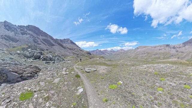 Mountain Biker Descending from Passo Invergneux into Grauson Valley, Aosta Valley, Italian Alps