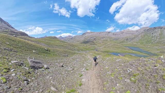 Mountain Biker Descending from Passo Invergneux into Grauson Valley, Aosta Valley, Italian Alps