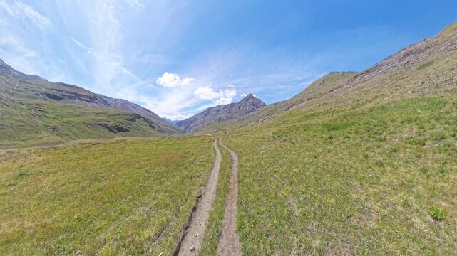 Mountain Biker Descending from Passo Invergneux into Grauson Valley, Aosta Valley, Italian Alps