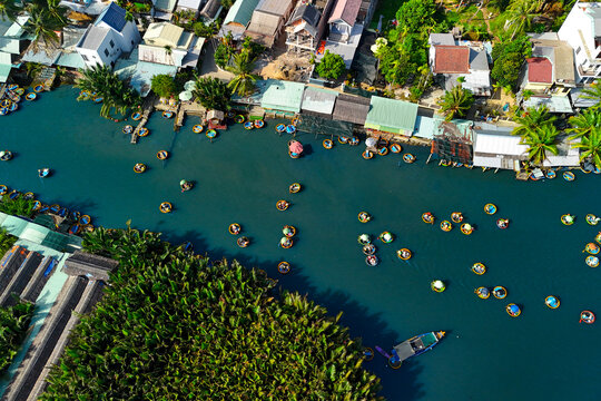 Tourists riding bamboo multitude basket boats on a river tour