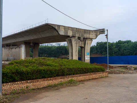 Broken concrete bridge section and support pillars in construction site
