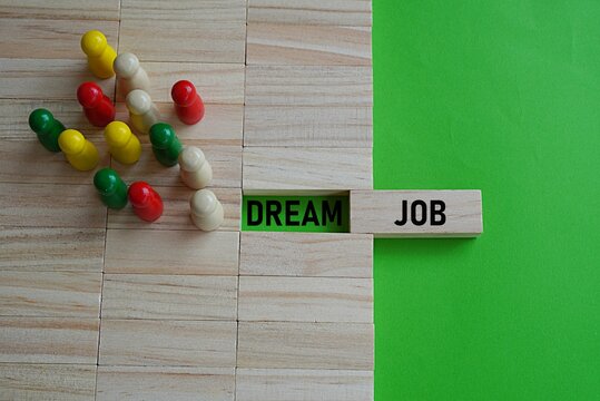 DREAM JOB. Job concept. Job search that fulfills life goals. High-paying job, promotion opportunities. Wooden figure background representing employees