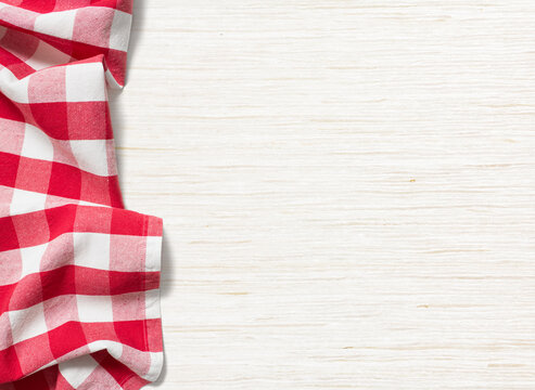 Red and white checkered tablecloth on a rustic wooden table with tablecloth checkered background material restaurant