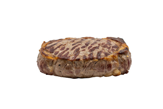 A single grilled beef filet mignon steak with charred grill marks on a white surface isolated on a transparent background