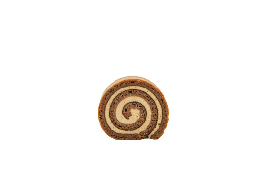 A single slice of chocolate swiss roll cake with creamy filling swirls isolated on a transparent background