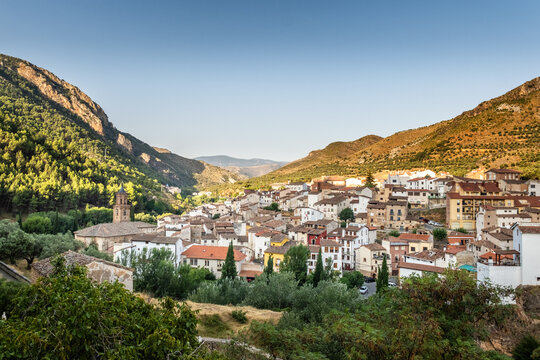 The church and village of Arnedillo in the Rioja region of Spain famous for it's thermal baths with mountains behind