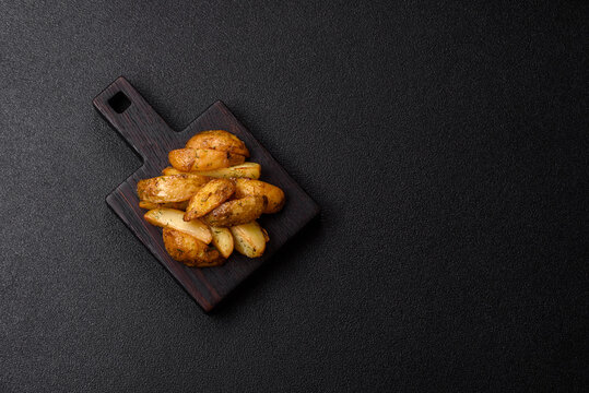 Fried potato wedges seasoned with salt and spices, ready for dinner table. Fried potato wedges