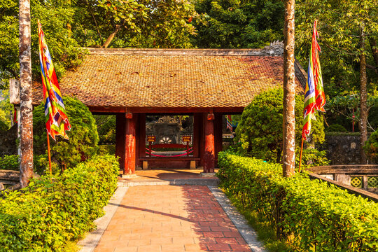 Ancient temple gateway with traditional flags in Hoa Lu, Ninh Binh, Vietnam