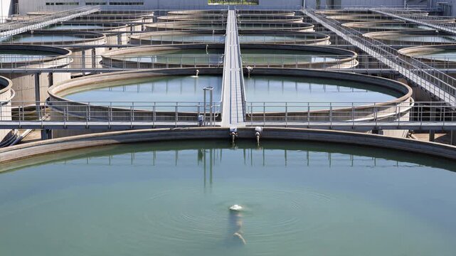 Water treatment plant showcasing circular sedimentation tanks for sewage purification, highlighting modern industrial water recycling and filtration technology
