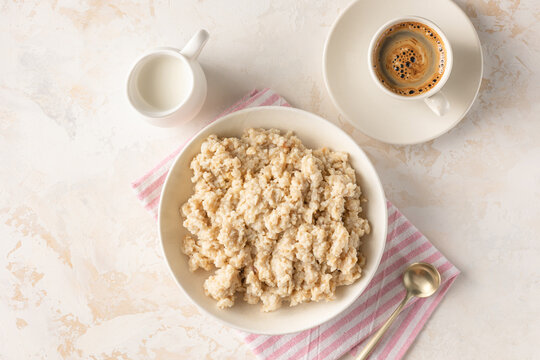 Oatmeal porridge bowl with fresh berries and cup of espresso black coffee