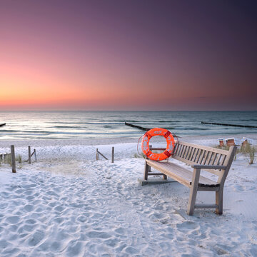 Silent Seaside Landscape with Lifebuoy and Bench at Golden Hour