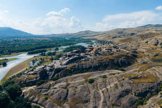 Aerial view of the ancient rock-hewn town of Uplistsikhe situated on a rocky plateau overlooking the Mtkvari River in Kvakhvreli, Shida Kartli, Georgia.
