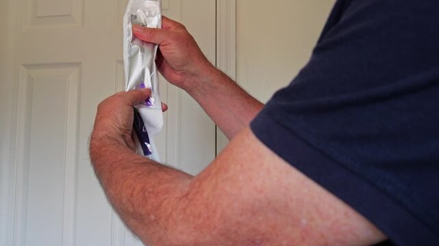 Preparing a male intermittent cather squeezing sterile line into cather bag in preparation for use