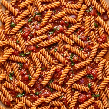 Photorealistic top-down view of cooked fusilli pasta with rich tomato sauce and fresh herbs for culinary blog content, restaurant menus, and food packaging designs.
