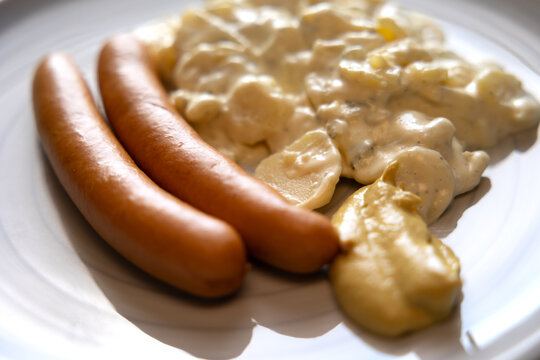 Bockwurst with potato salad and mustard. Lunch, dinner, kitchen, sausage, meal, restaurant, mayonnaise, table.