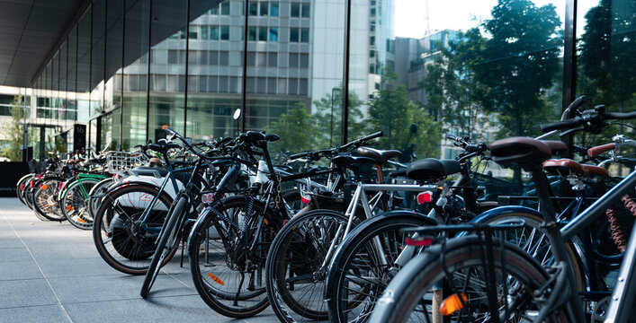 Bicycles in front of an office building in Frankfurt am Main. Business, transport, bicycle lane, parking place, facade, office building.