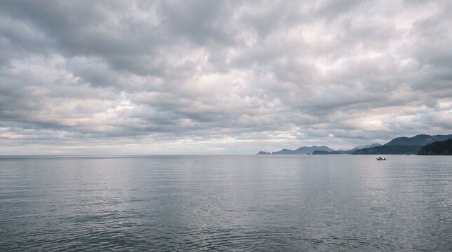 Overcast Sky Over Calm Ocean Waters with Distant Coastline