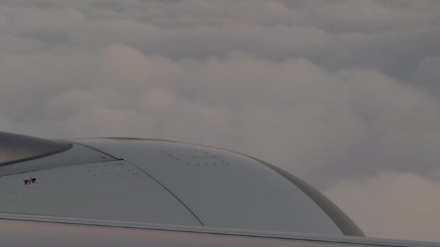 Close View of Airplane Wing Above Endless Cloud Layer