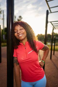 Smiling young woman relaxing after outdoor workout