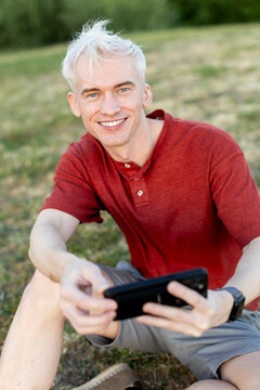 Portrait of man using smartphone in the park