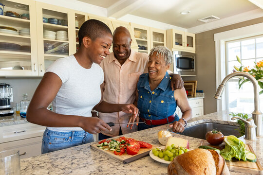 Black Family laugh together portrait   Lifestyle cooking kitchen 