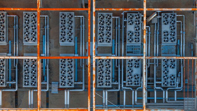 Aerial view of industrial HVAC cooling units and ventilation systems arranged on a rooftop in the EUR district of Rome, Lazio, Italy.