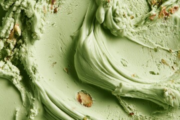 Obraz premium Mint green ice cream with nuts swirled in a container