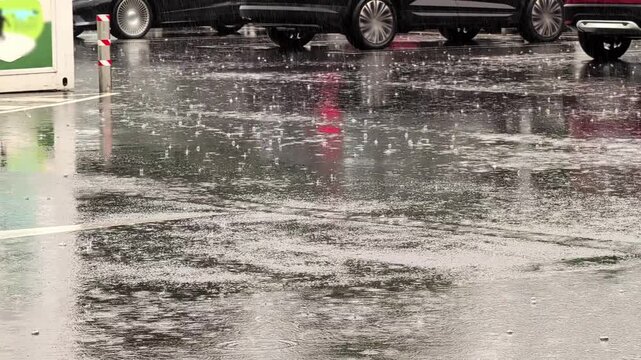 Car Driving On Wet Street Asphalt During Heavy Rainstorm Downpour In City Parking Lot