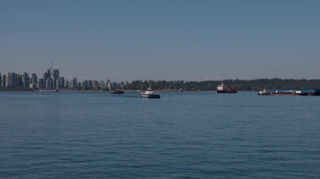 Seabus or Passenger Boat with a Tugboat crossing Burrard Inlet at Vancouver, Canada travel and tourism