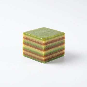 Traditional Indonesian kue lapis layer cake cube dessert served on a clean white background