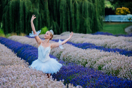 A ballerina gracefully dances outdoors in a lavender field