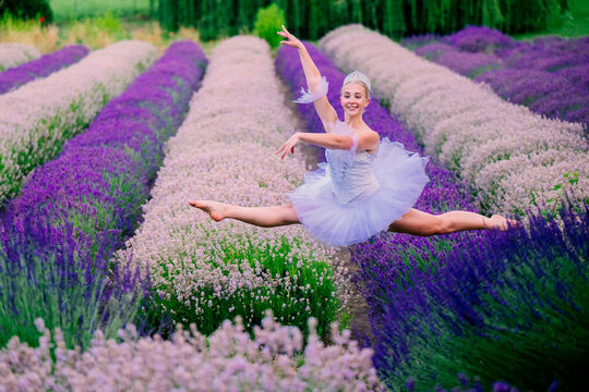 A ballet white dancer leaps gracefully through rows of blooming