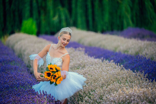 A ballerina holds sunflowers gracefully in a lavender field in WA, USA