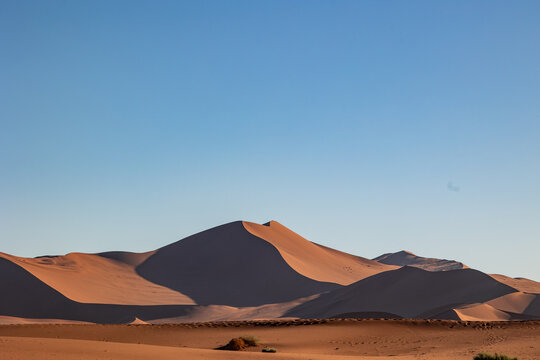 Towering sand dunes forming shapes in Namib Desert