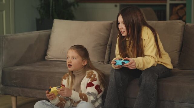 Two girls compete in a video game with gamepads, having fun together at home