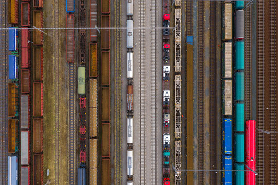 Aerial view of colorful freight train cars parked on parallel tracks at a railway yard Breclav, South Moravian Region, Czechia.