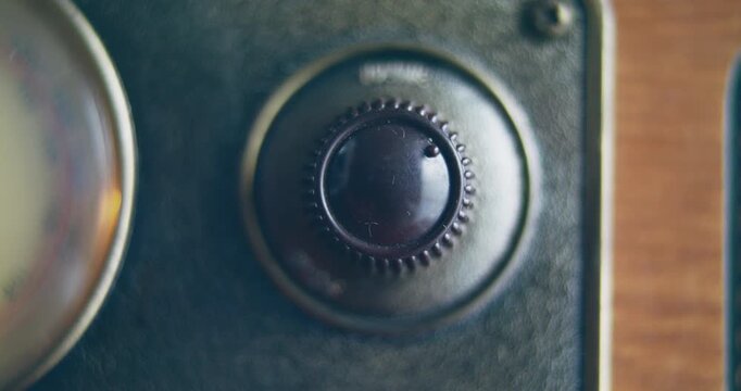 Close up shot of knob turning for changing volume on a vintage radio