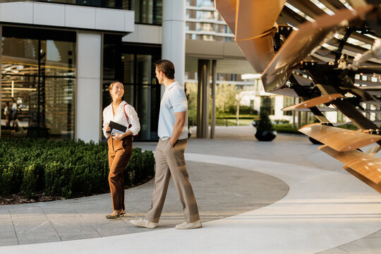 Couple enjoying a sunny day while strolling through a modern urban landscape