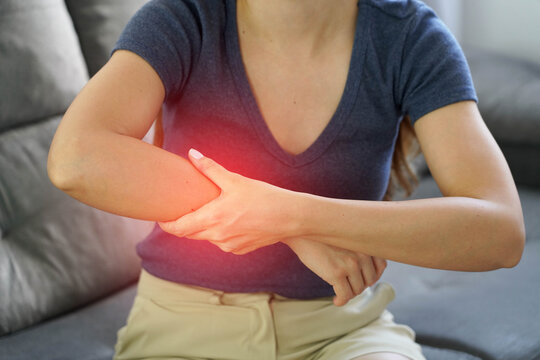 Close Up of Woman Massaging Her Numb Arm to Improve Blood Circulation