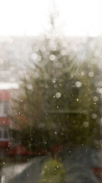 Raindrops on window glass surface as abstract moody background