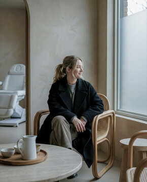 Woman sitting waiting in minimalist modern waiting room