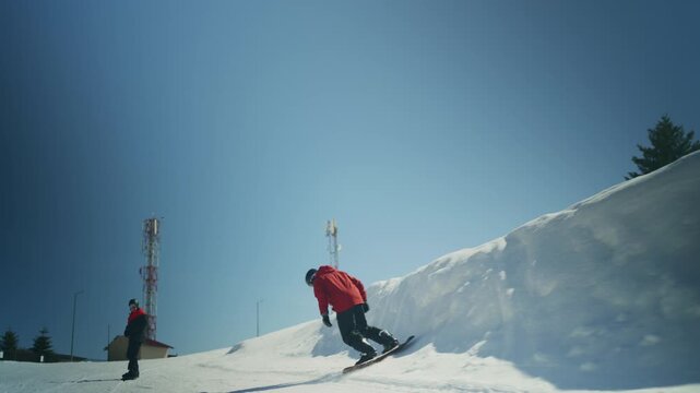 Two snowboarders navigate a snowy mountain slope on a bright winter day. The dynamic scene captures the thrill of winter sports at a ski resort.