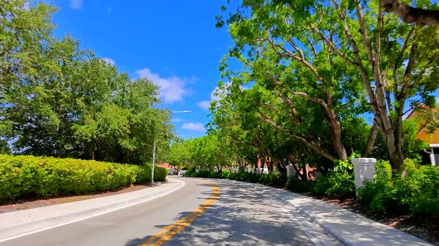 Slow motion video winding road Weston Florida residential district
