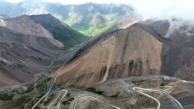 Aerial view of the winding road of Chon Ashu Pass, featuring sharp switchbacks carved into the rugged mountain terrain in Karakol, Issyk-Kul Region, Kyrgyzstan.