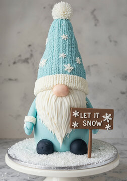 Cute Winter Gnome Figure Wearing Blue Knit Hat with Let It Snow Sign