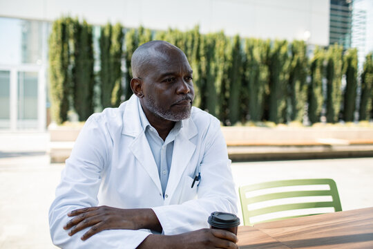 Doctor with coffee during outdoor hospital break