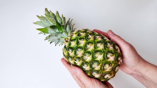 Vibrant fresh pineapple displayed on a clean white surface, tropical bounty suggesting summer refreshment, perfect for healthy recipes or bright kitchen decor