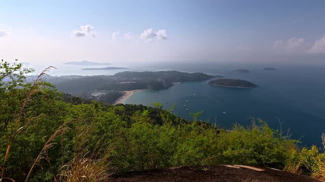 Breathtaking view of Nai Harn Beach and Ao Sane facing the Andaman sea seen from the Black Rock viewpoint or Pa Hin Dum, a popular hiking trail in Phuket, Thailand