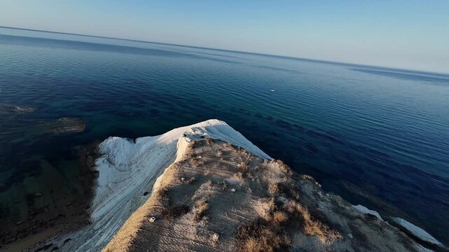 FPV drone descent over Scala dei Turchi white cliffs in Sicily, Italy