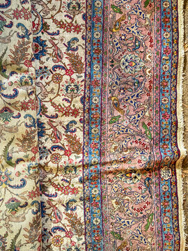 Close up of antique Persian wool rug with floral border pattern